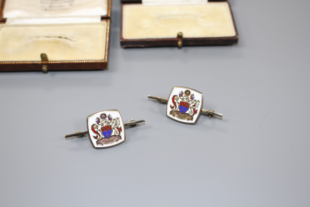 A modern pair of silver gilt and enamel brooches, decorated with ornate crest, 42mm, gross weight 14.6 grams.